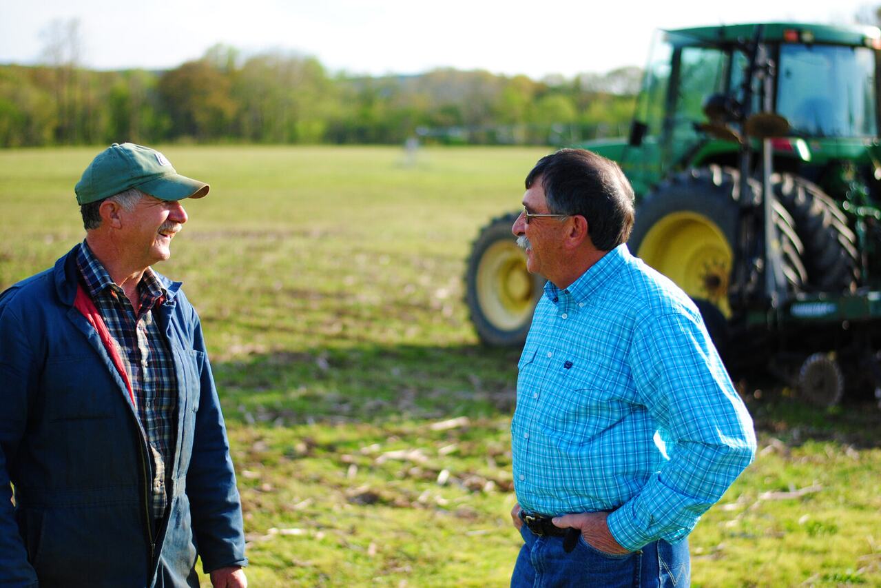 Rick West visiting with a farmer